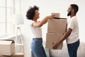 Happy Couple Packing Moving Boxes Together